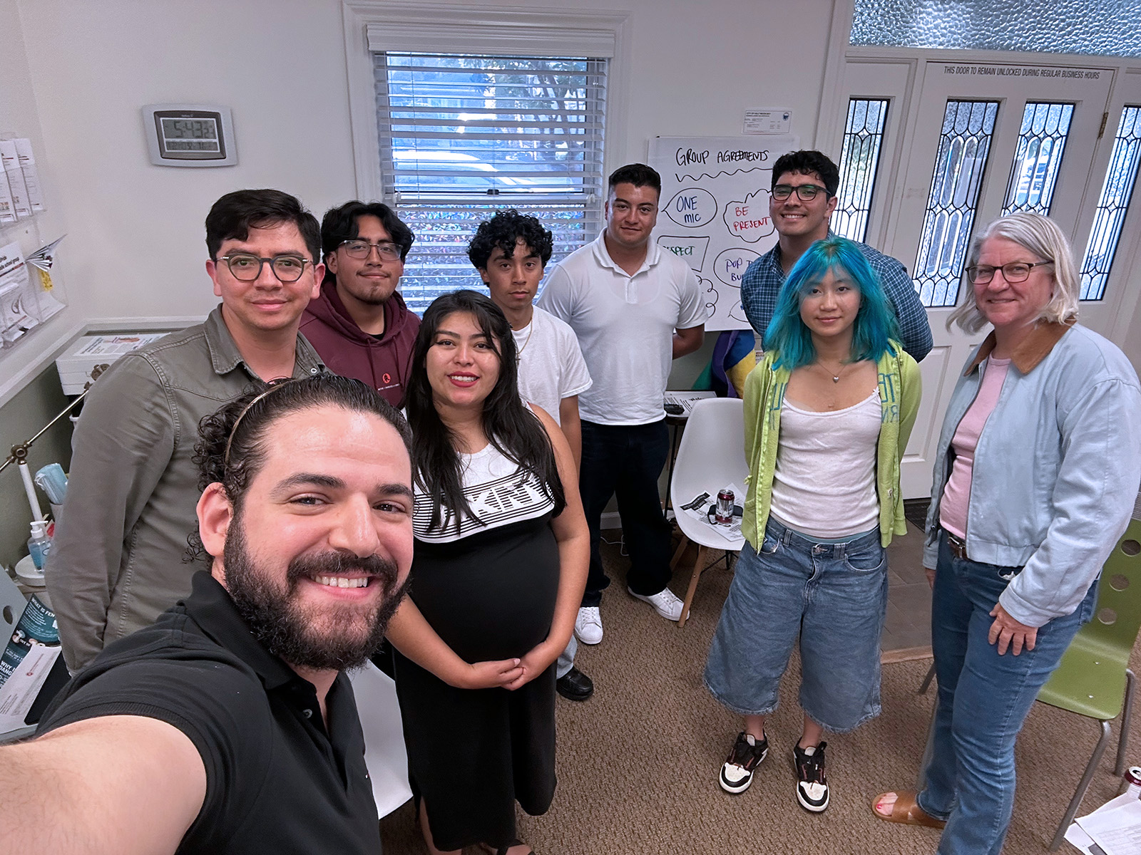 allcove group selfie with 9 people in coastpride center
