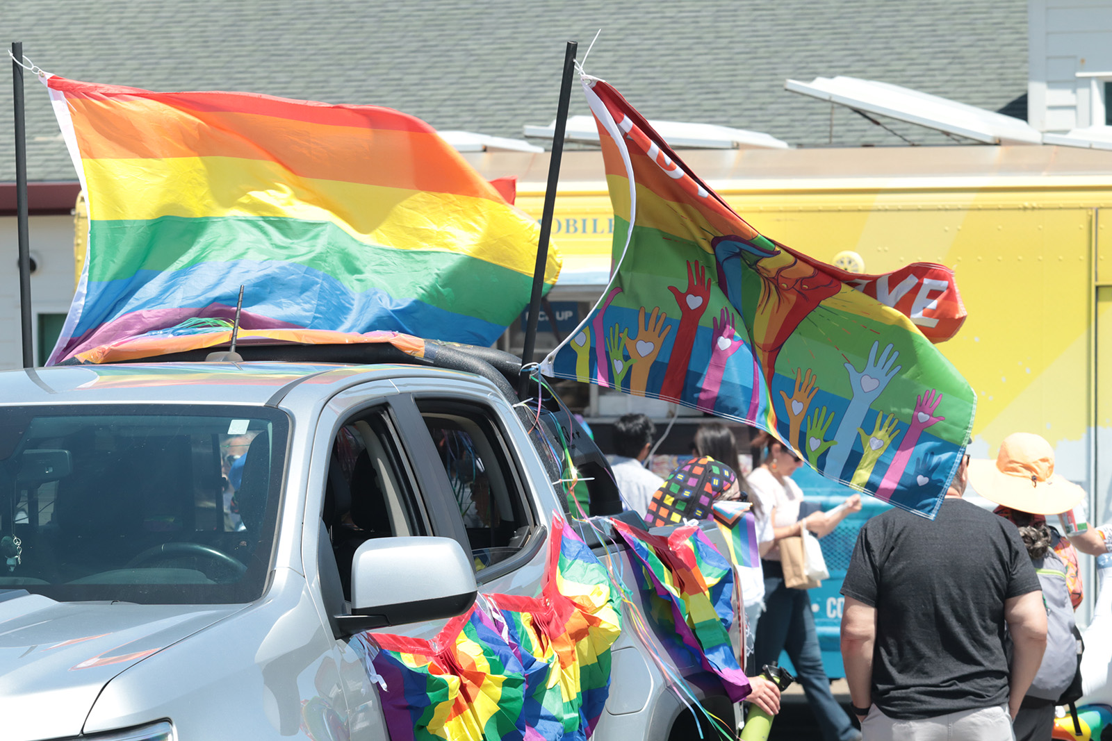 silver pickup with pride and unity flags and bunting